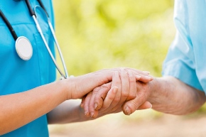 doctor and patient holding hands